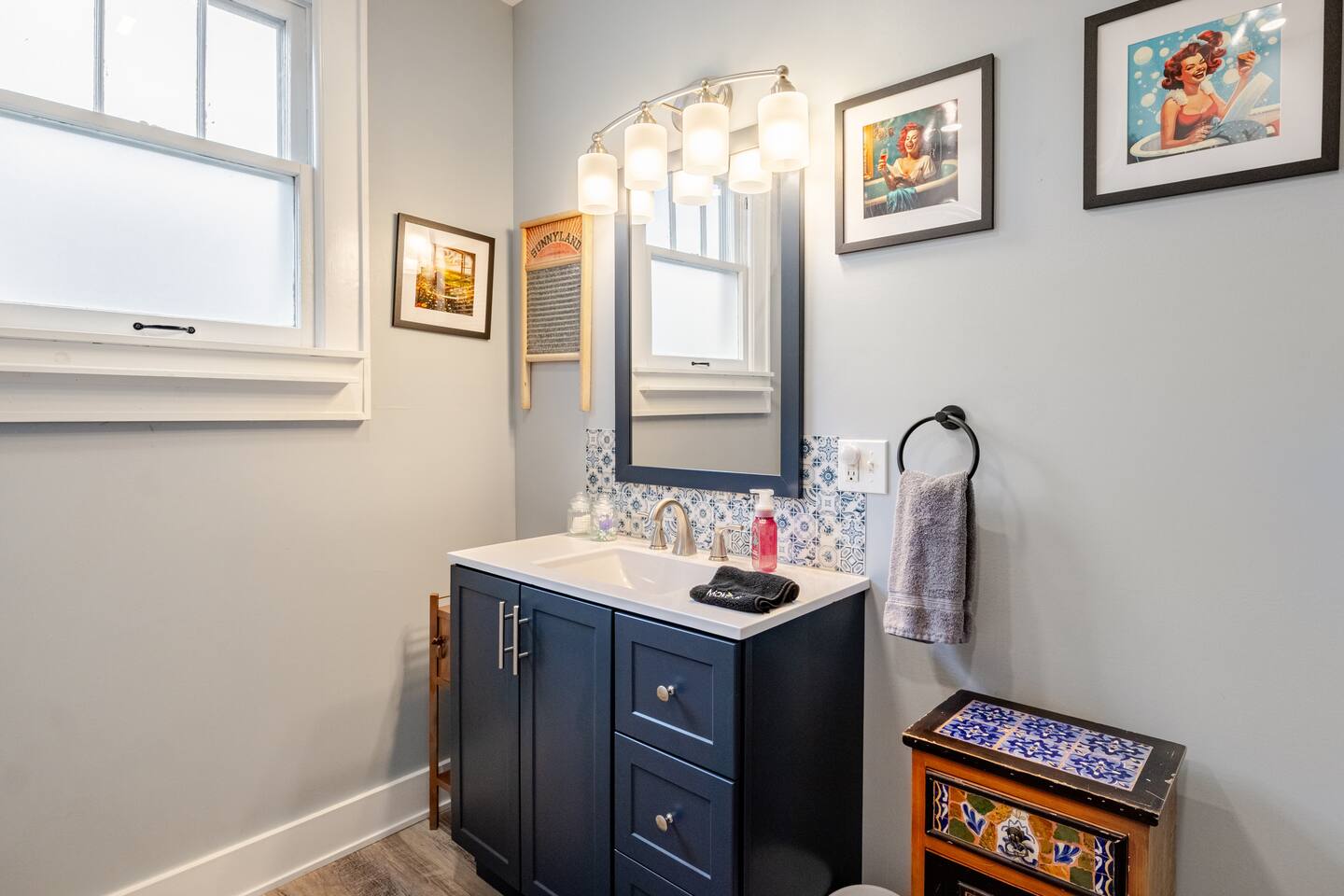 Bathroom after restoration: custom vanity, tile, and refinished fixtures