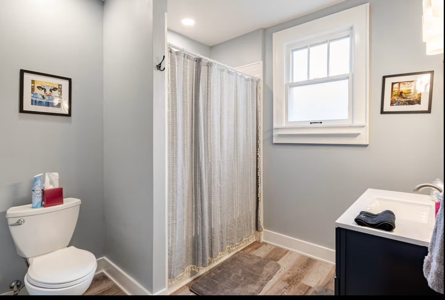 Bathroom after restoration: full view with refinished fixtures, new tile, and updated finishes