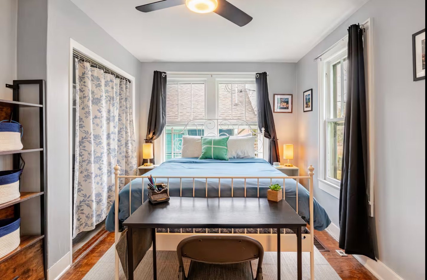 Bedroom after restoration: refinished hardwood floors, restored windows, and updated finishes