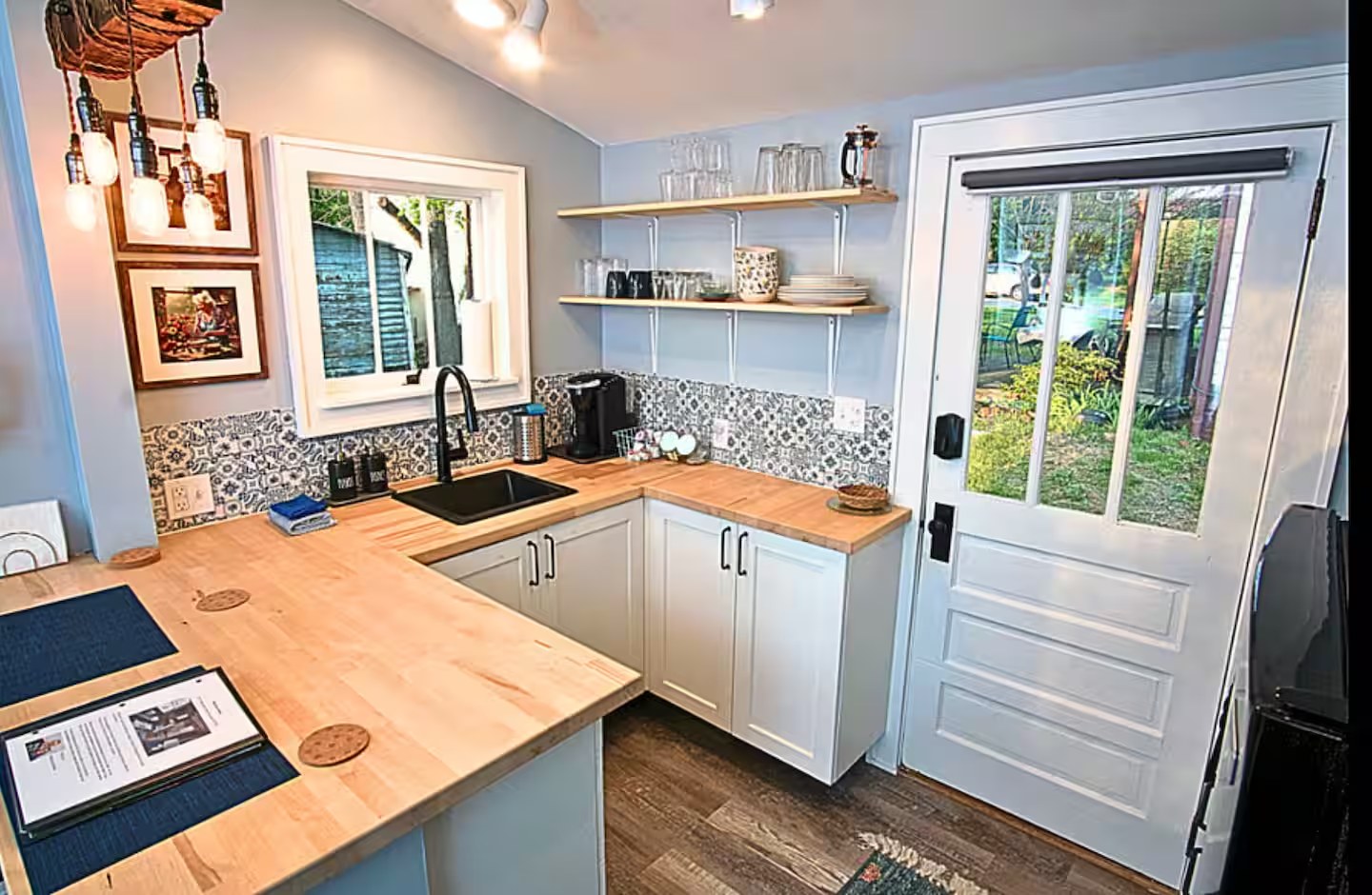 Kitchen after restoration: refinished flooring, new cabinetry, and updated fixtures