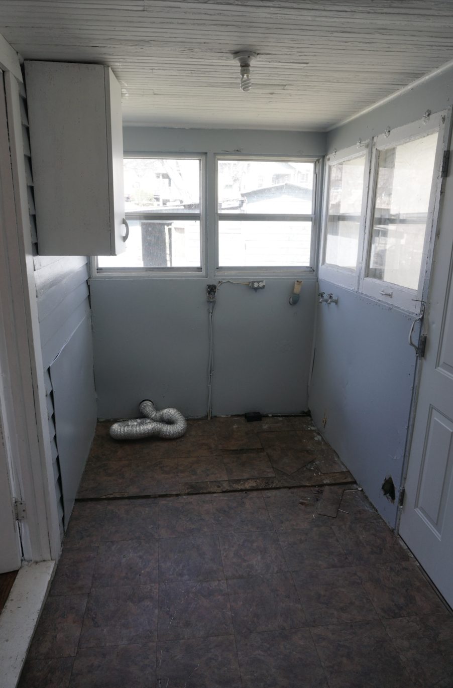 Kitchen before restoration: original cabinets and outdated layout
